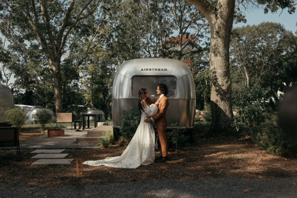 Couple posing in front of an Airstream that they eloped at in Autocamp Cape Cod.