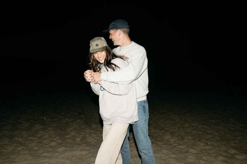 Casual love session with flash at night on the beach in southern California 