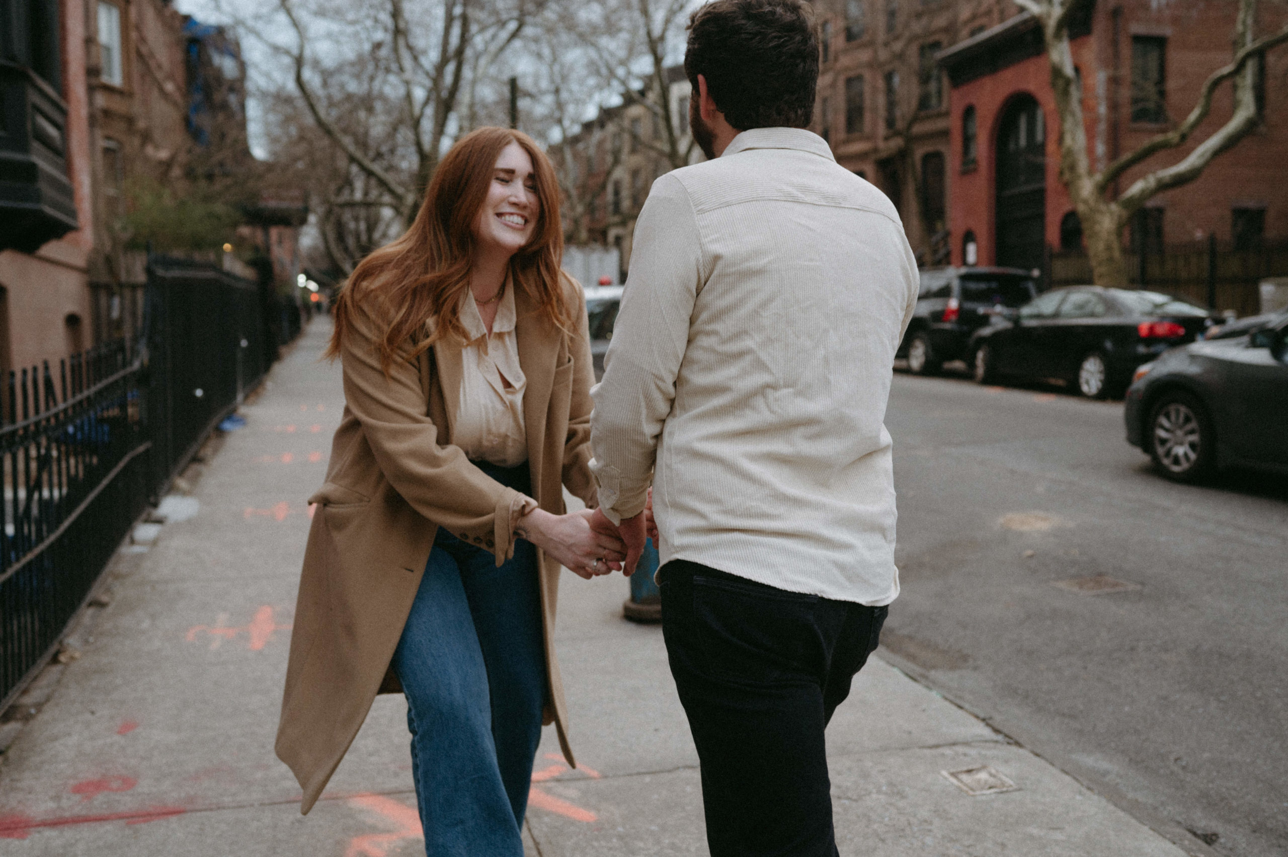 Couple smiling on the street in Brooklyn, NY