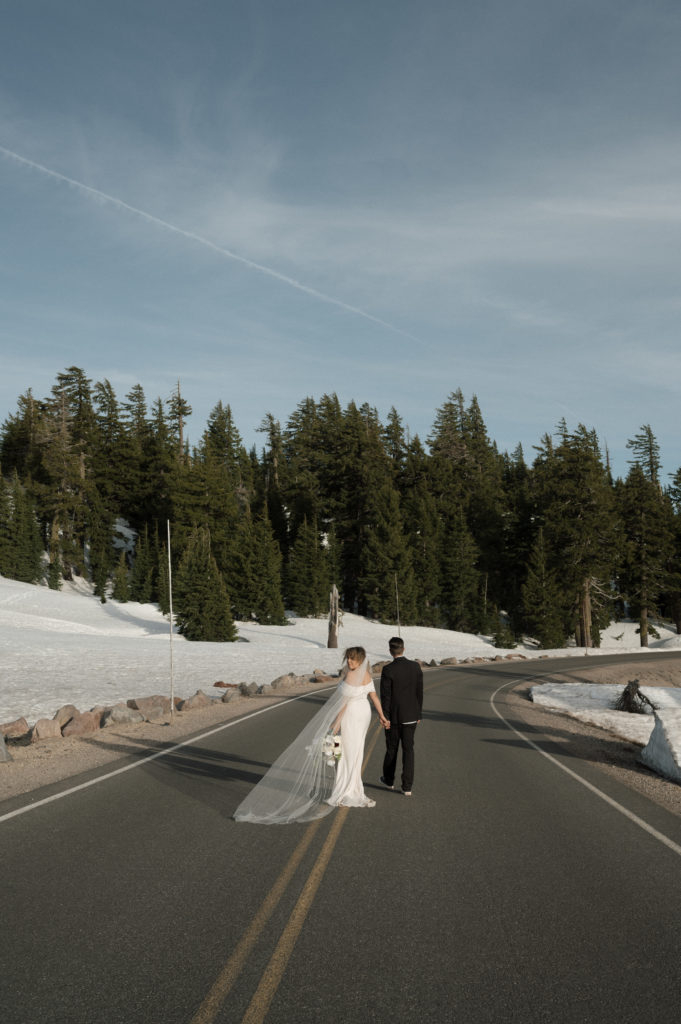 Couple walking away down the road after their elopement in Oregon.