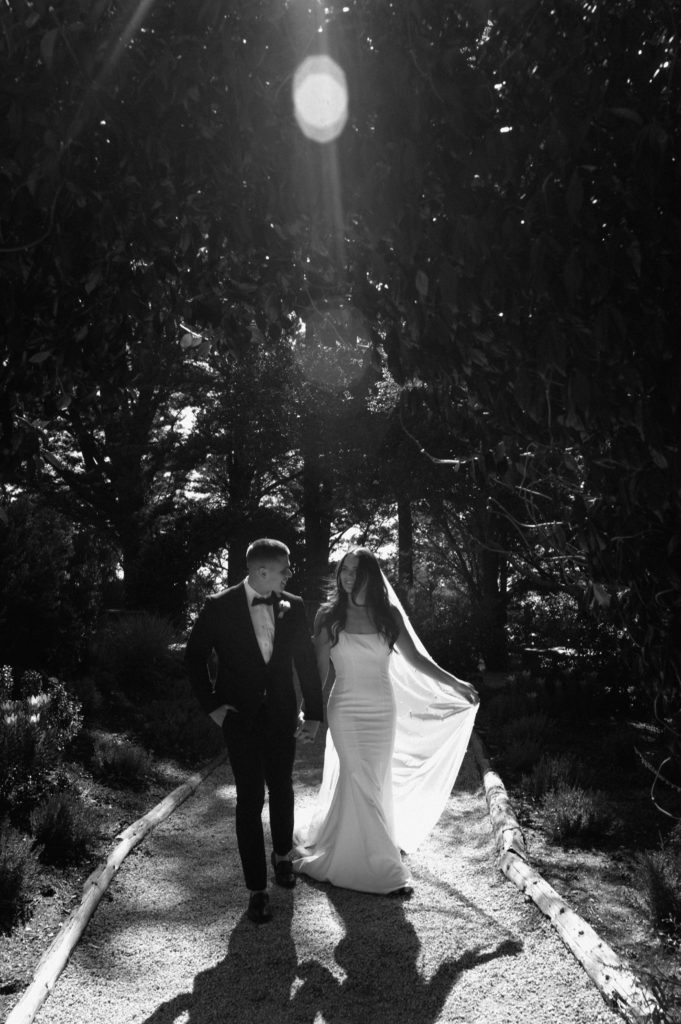 Couple walking down the path in Ventana Big Sur after saying I do in black and white 