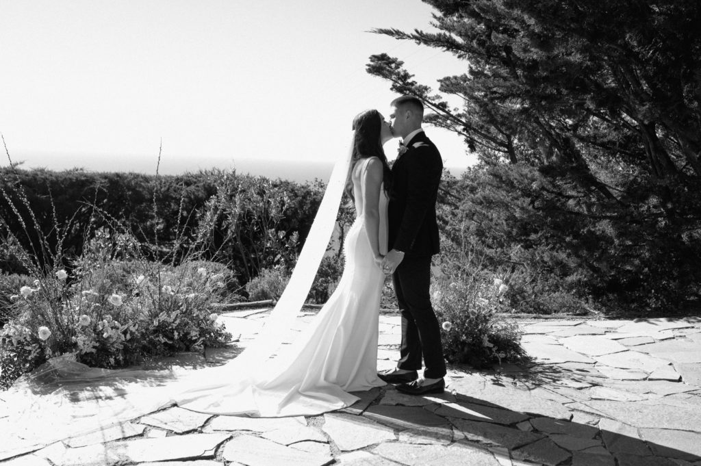 Couple kissing after saying vows on the Big Sur coast