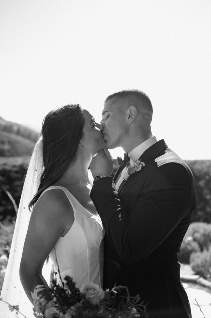 Black and white portrait of couple kissing in Big Sur, California