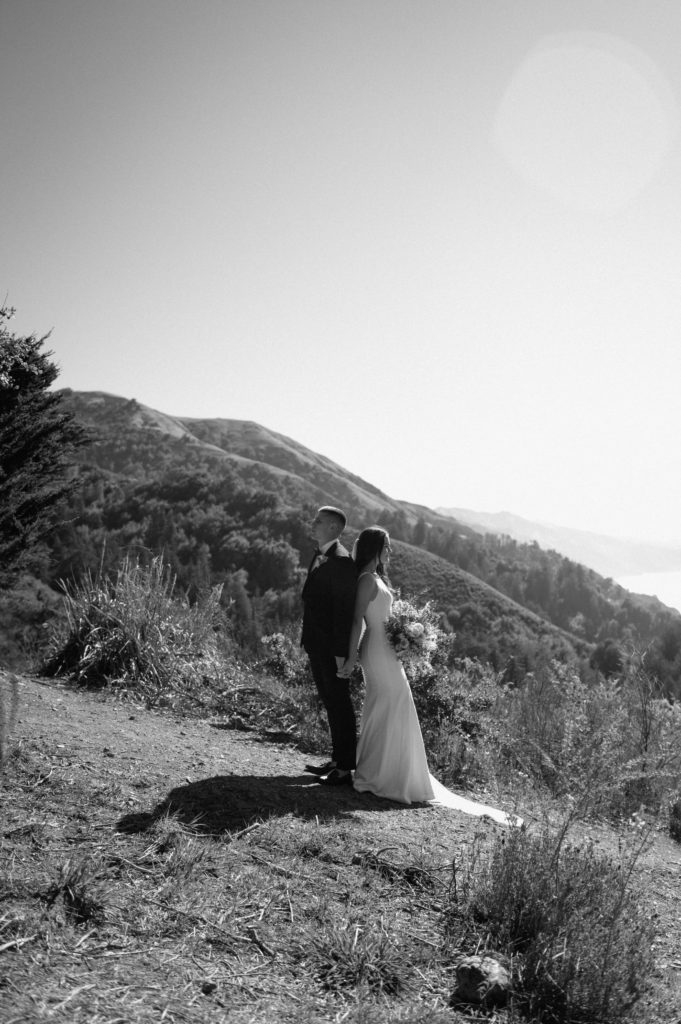 Black and White couples portrait in front of the coastal mountains in Big Sur