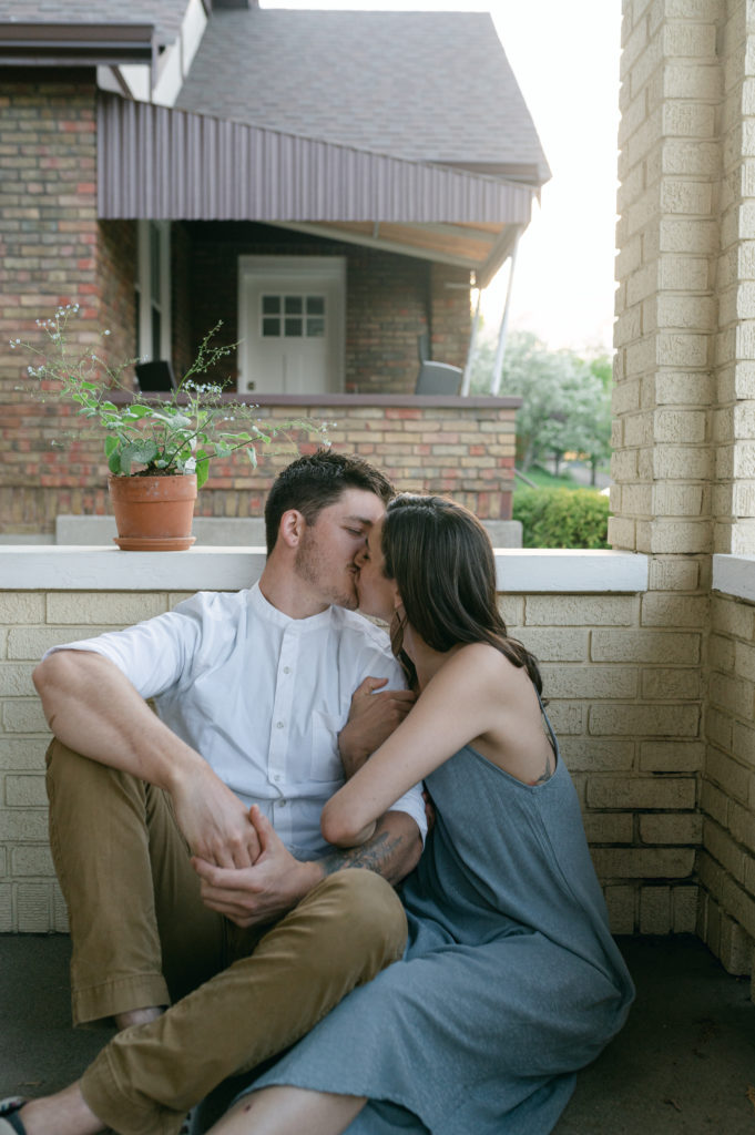 Couple kissing on their front porch in Cincinnati 