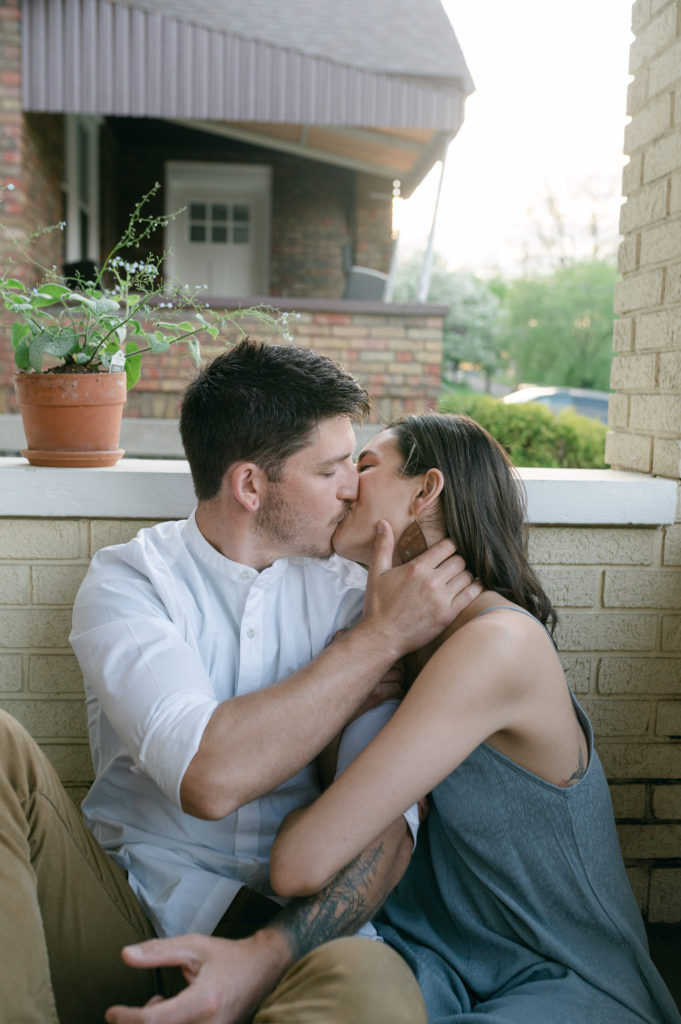 Couple kissing on their front porch in Cincinnati, Ohio