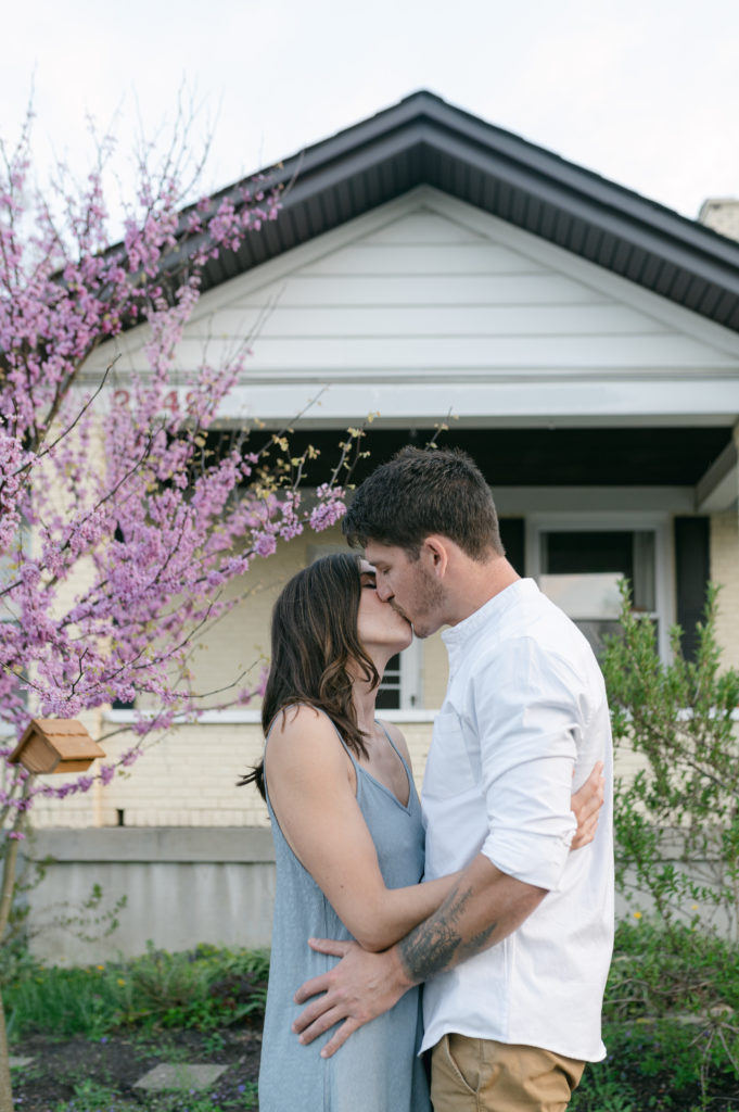 Couple kissing in front of their craftsman hoe 