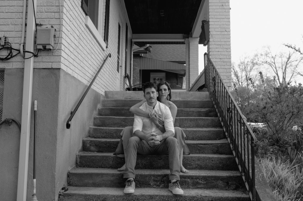 Couple sitting on their steps photographed in black and white 