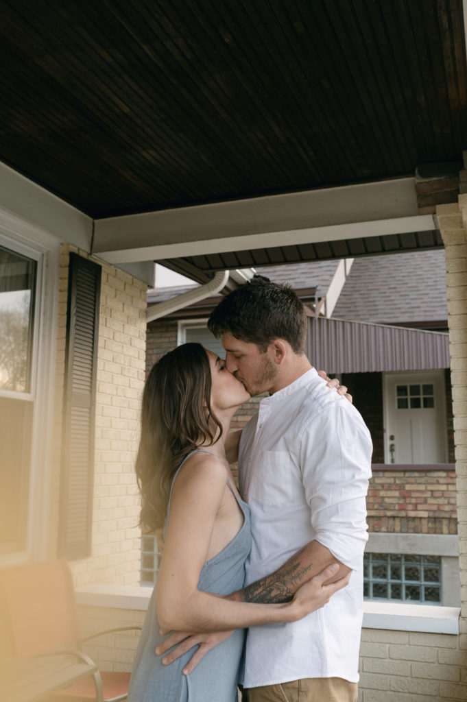 Couple kissing on their front porch