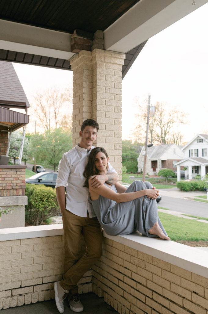 Couple posing on their porch in Cincinnati, Ohio.