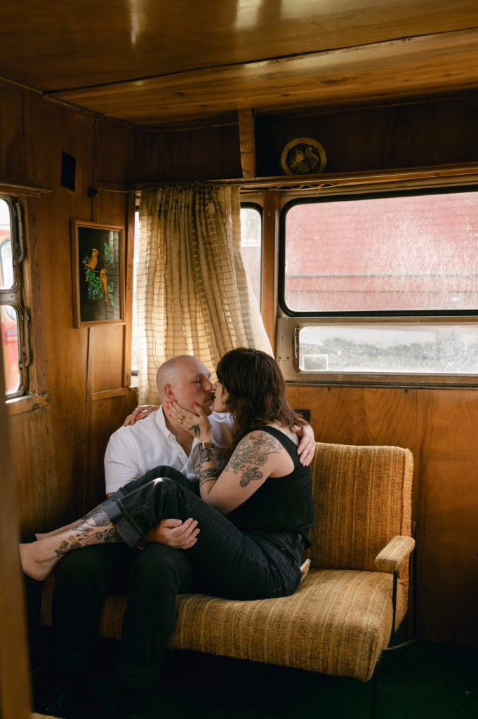 Couple snuggled up in vintage camper in Seaview