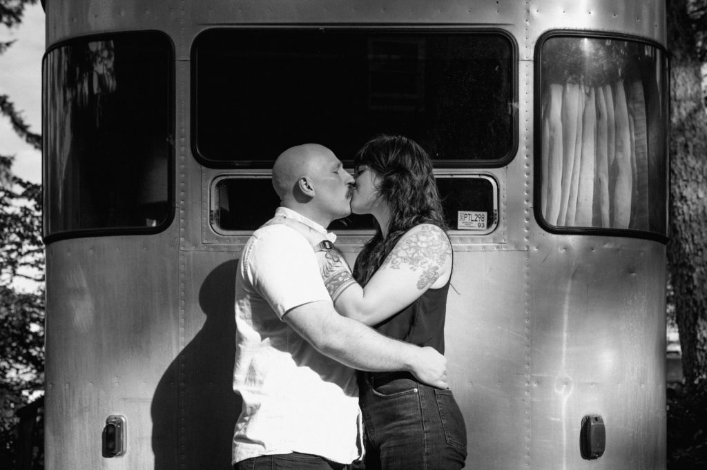 Couple kissing in front of camper at Sou'wester lodge in Seaview, Washington.