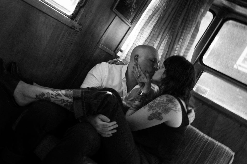 Black and white photo of couple in vintage camper 