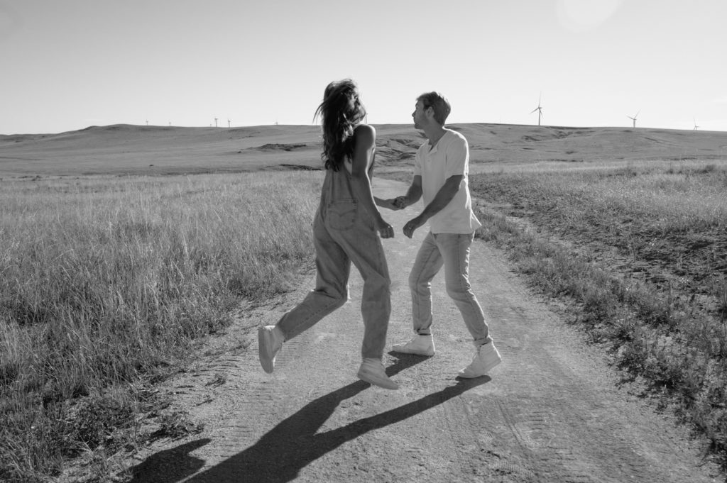 Couple in a field in front of Windmills 