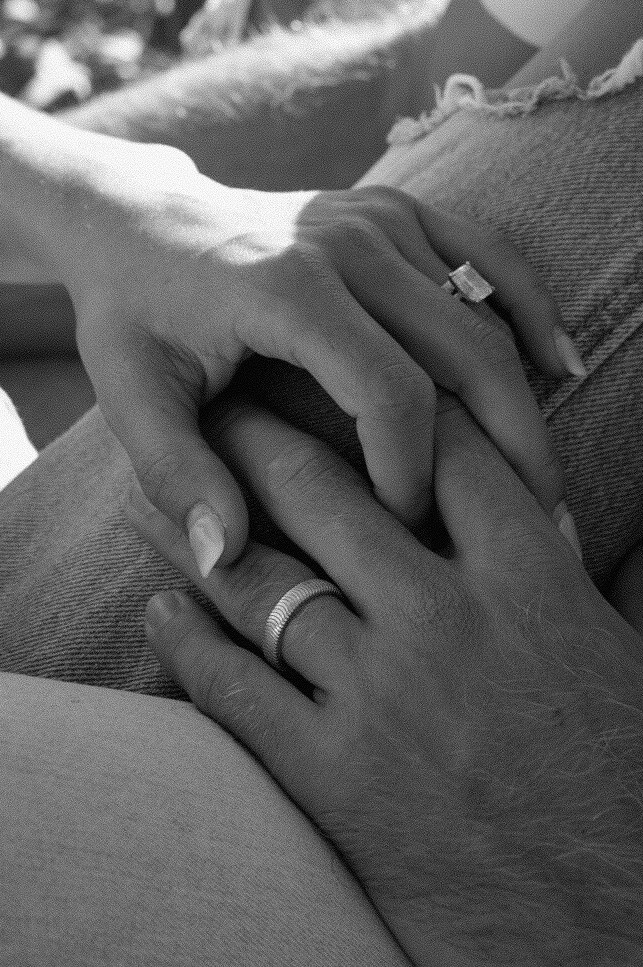 Black and white detail shot of married couple's rings 