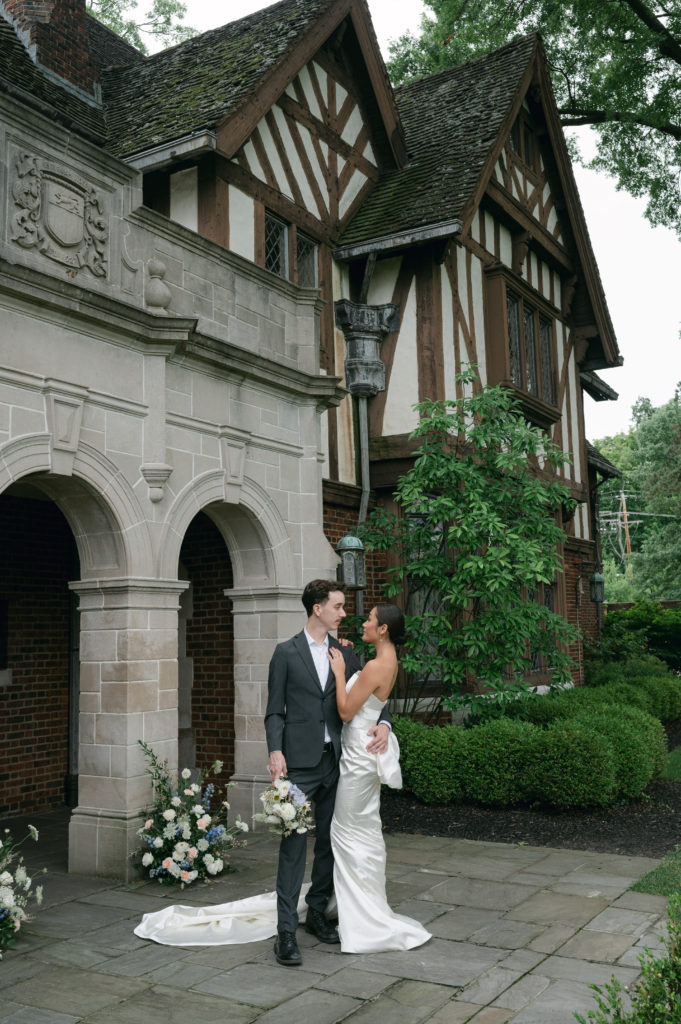 Luxury editorial couple posing in front Pinecroft Mansion