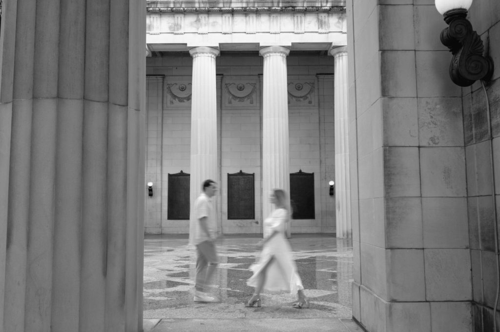 Motion blur photo in black and white of couple walking 