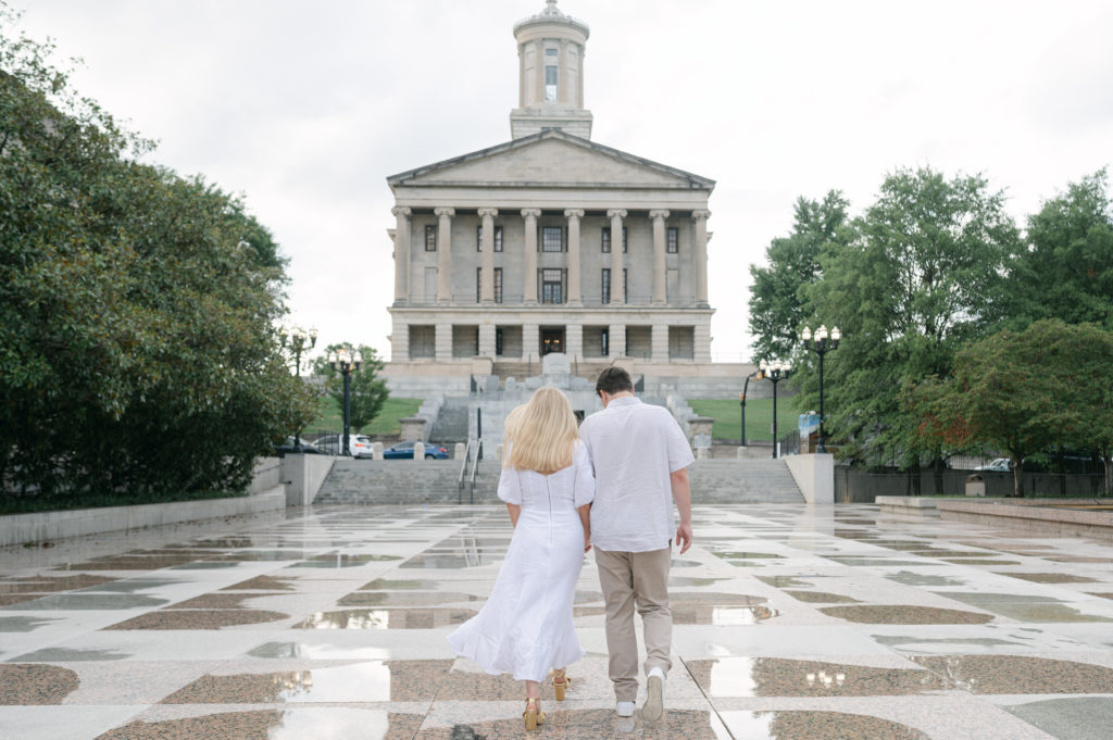 Couple walking toward the Capitol Building downtown Nashville 