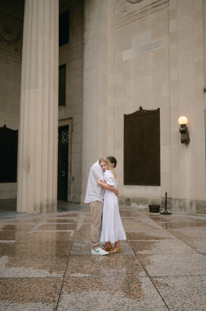 Couple hugging inside The War Memorial building.
