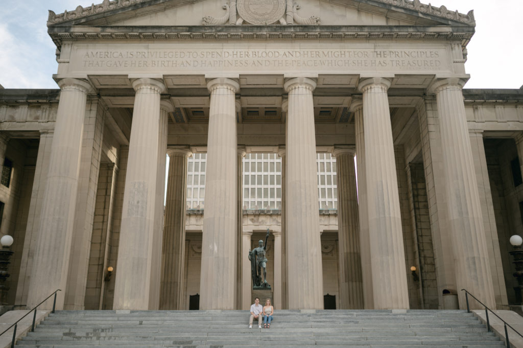 Future bride and groom posing in front of The War Memorial Building for their engagement photos in Nashville, Tennessee 