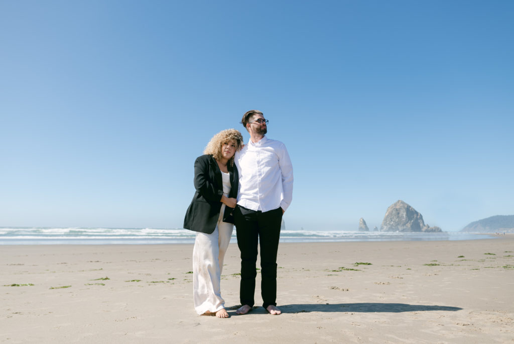 Couple posing on Cannon Beach on the Oregon Coast. 