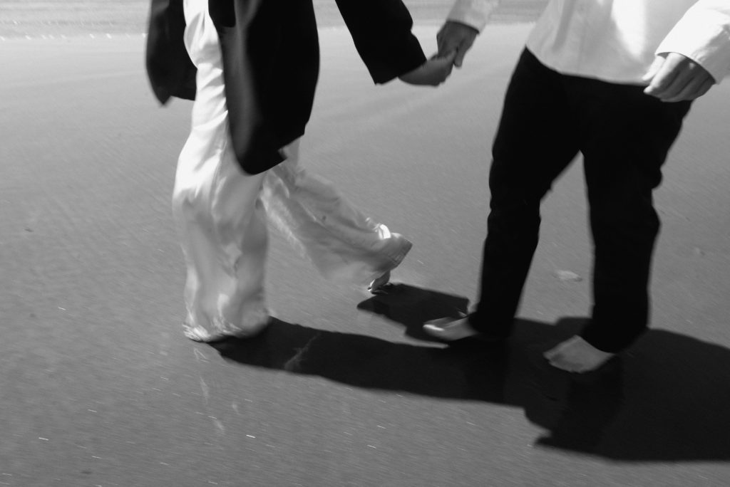Motion blur image of couple running on the beach.