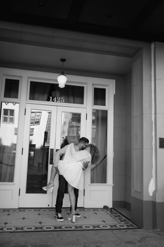 Black and white photo of groom dipping his fiancé for a kiss 