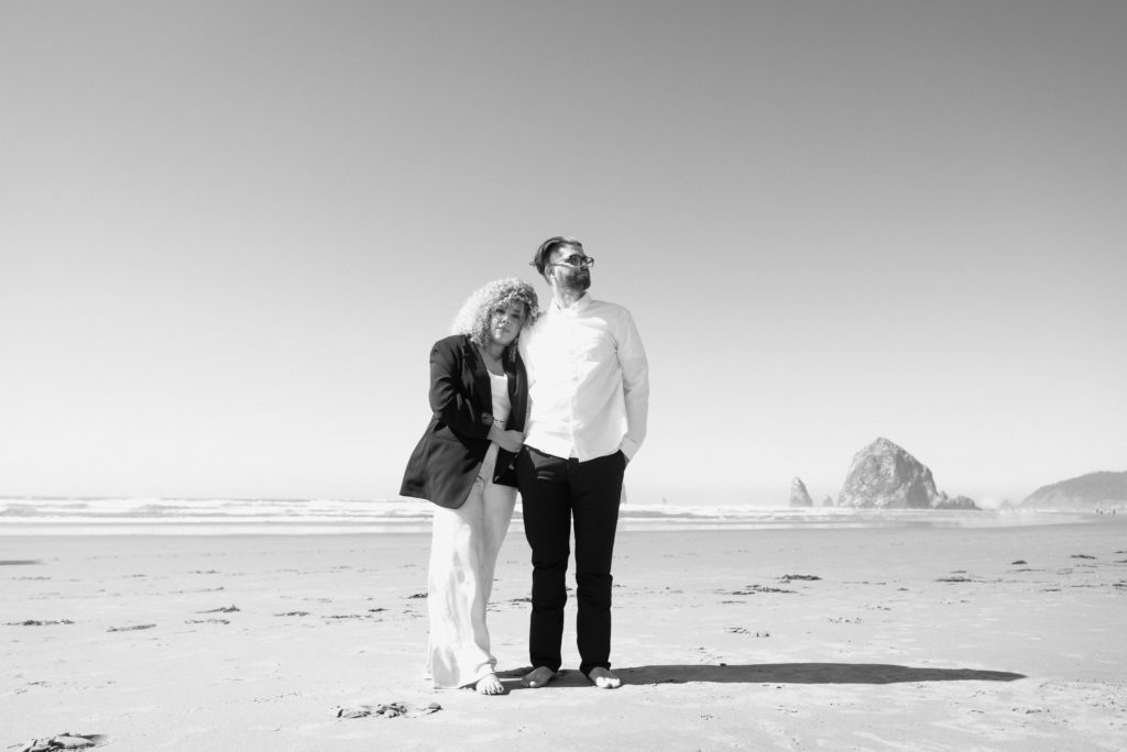 Editorial image of couple posing on Cannon Beach in Oregon 