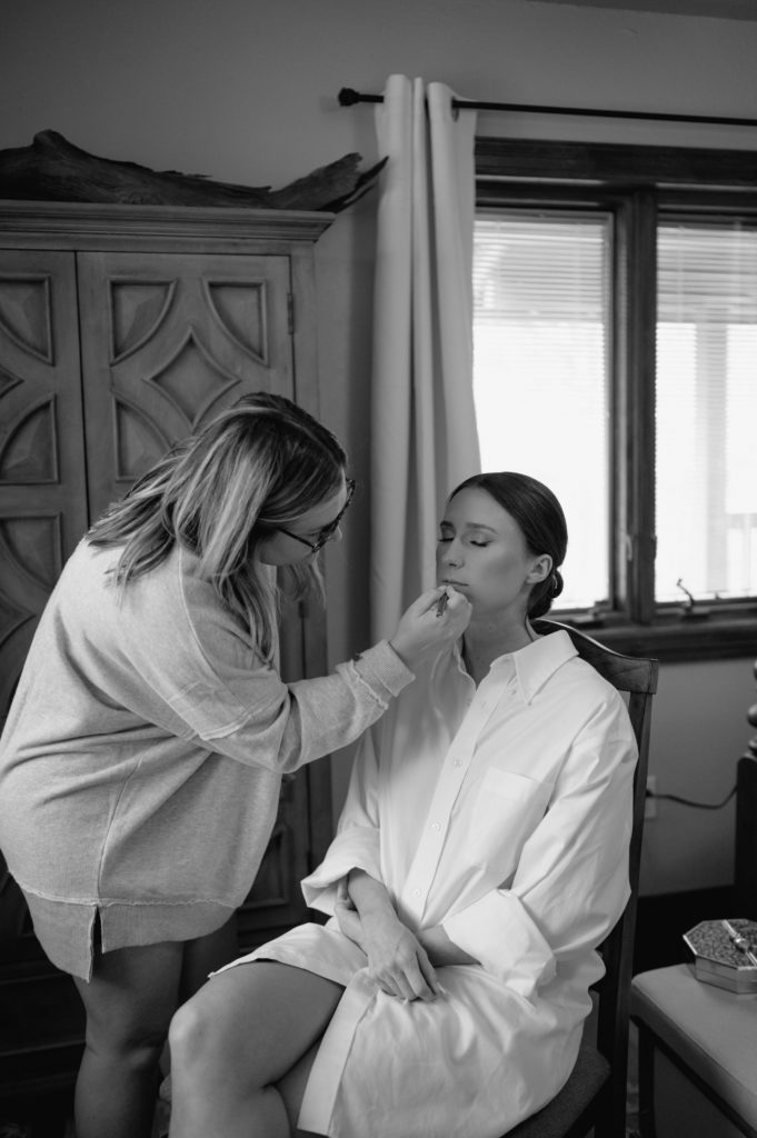 bride getting hair and makeup done 