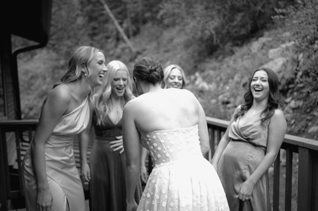 First look with bride and her bridesmaids in black and white 