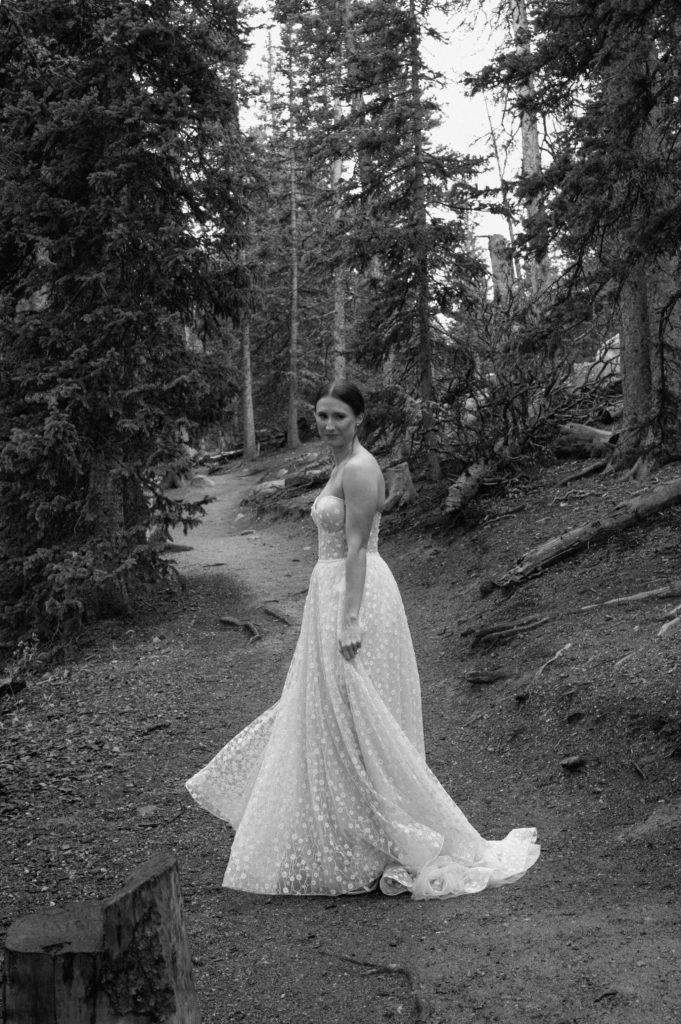 Black and white image of bride in the forest around echo lake 