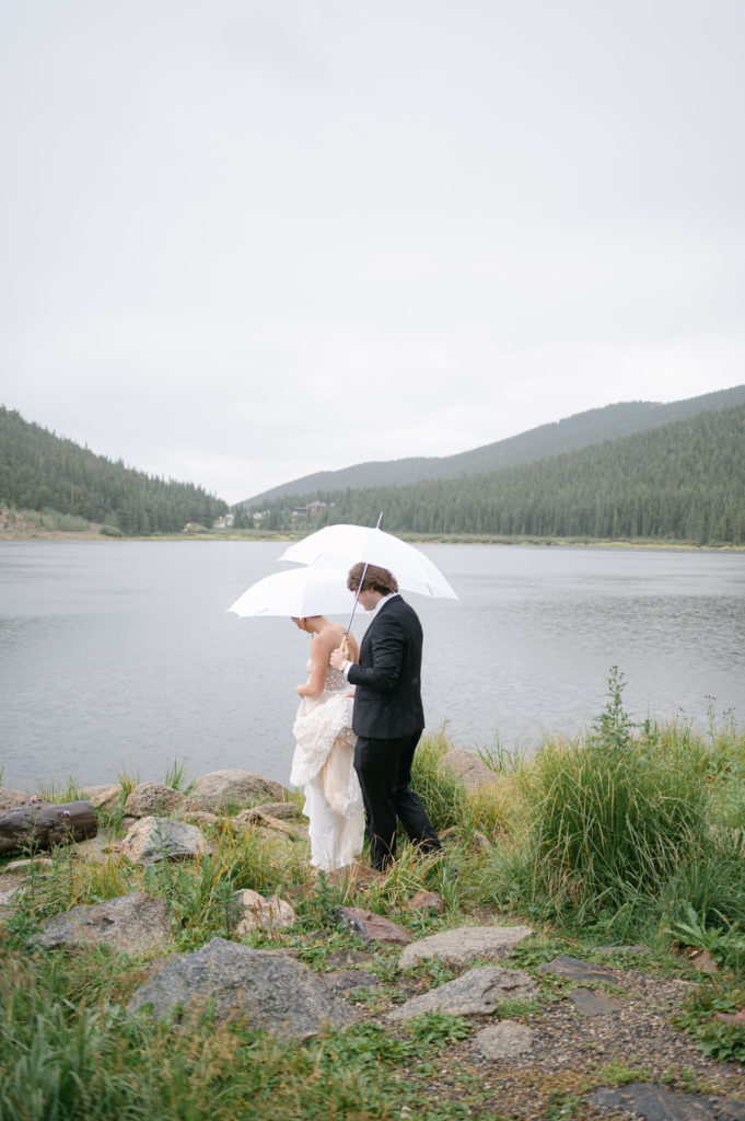 Bride and groom walking toward Echo lake for their wedding portraits 