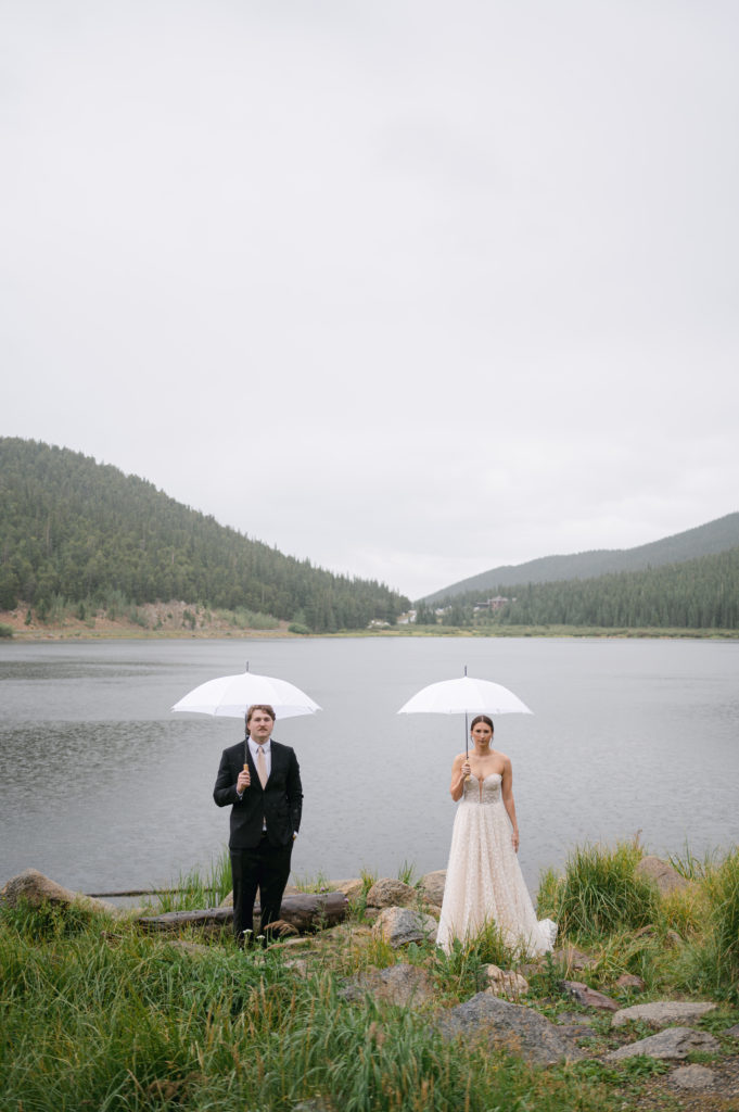 Bride and groom posing for romantic rainy portraits 