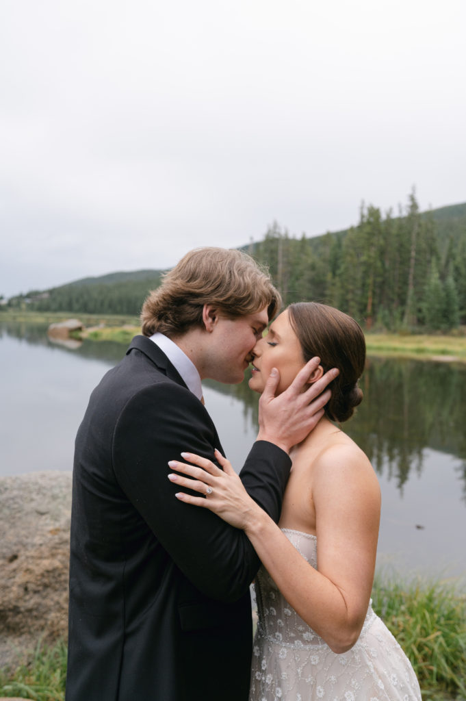 Romantic portrait of bride and groom kissing at echo lake 
