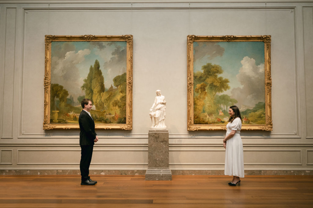 Couple posing for engagement photos in The National Gallery of Art in Washington DC