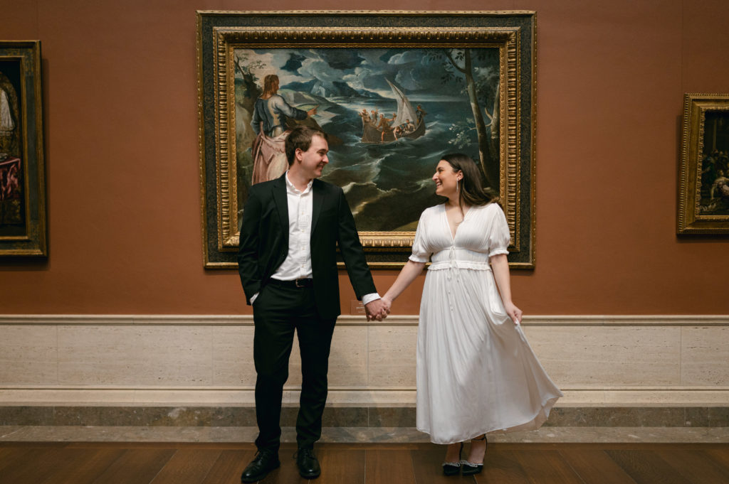 Couple posing for engagement photos in The National Gallery of Art in Washington DC