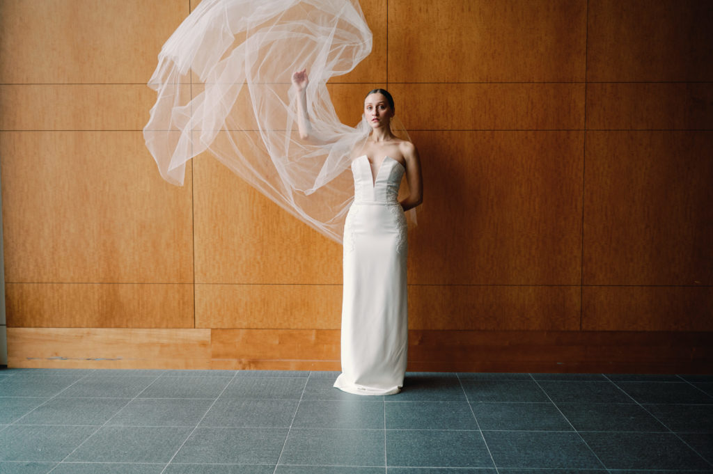 Bride throwing her veil during bridal portraits 