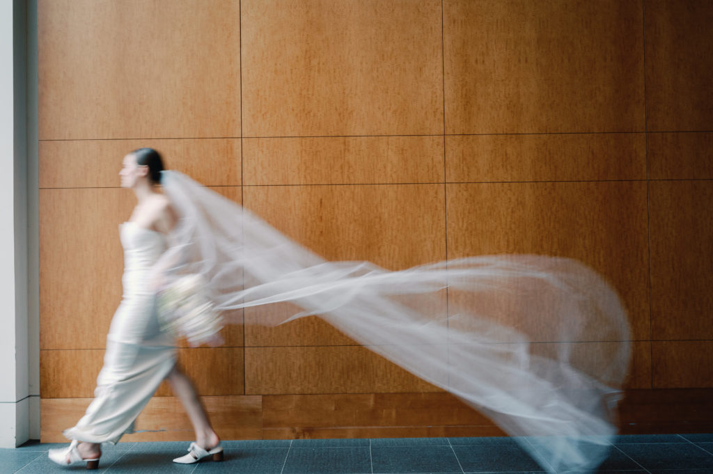 Motion blur bridal portrait of a bride in an art museum. 