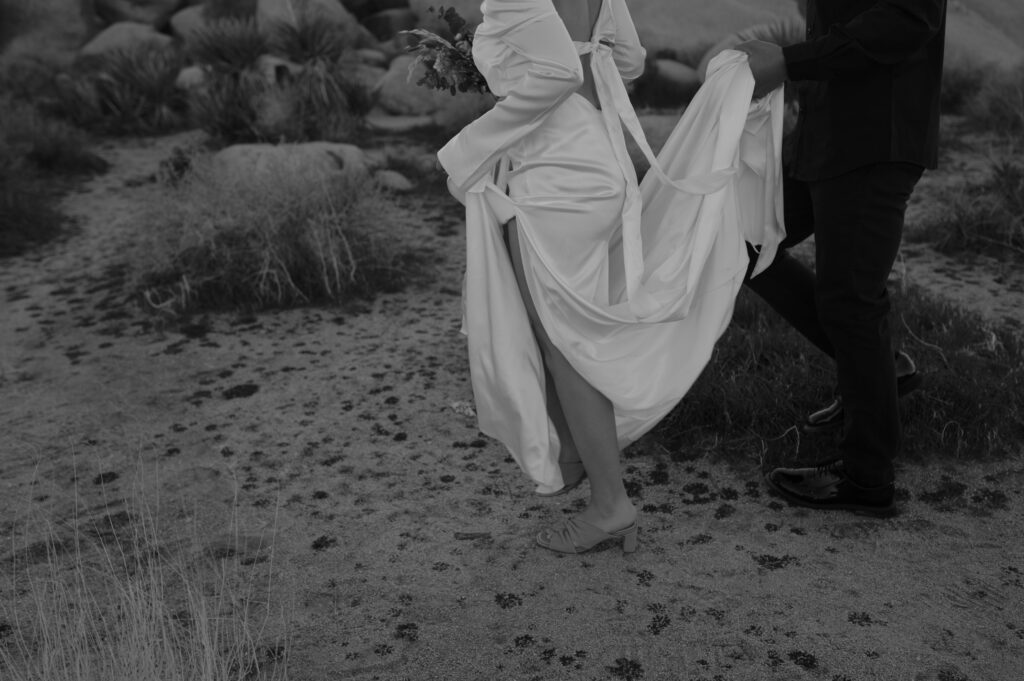 Bride and groom walking in the Joshua Tree Desert 