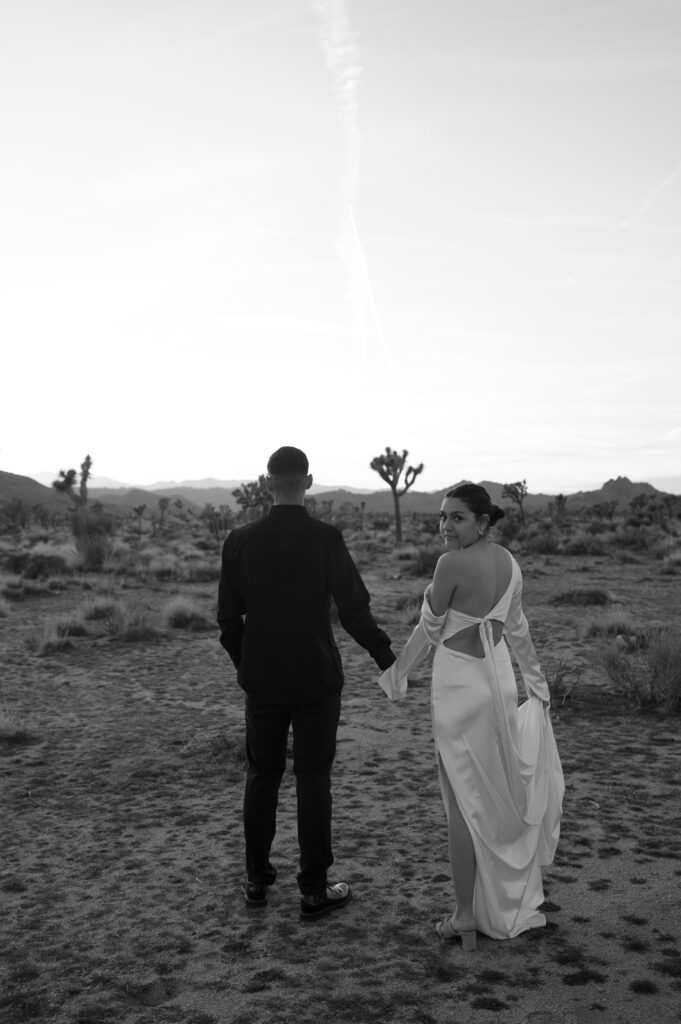Couple walking into the sunset in Joshua Tree National Park 
