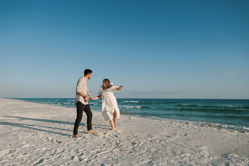 Couple playing tag on the beach in Florida 