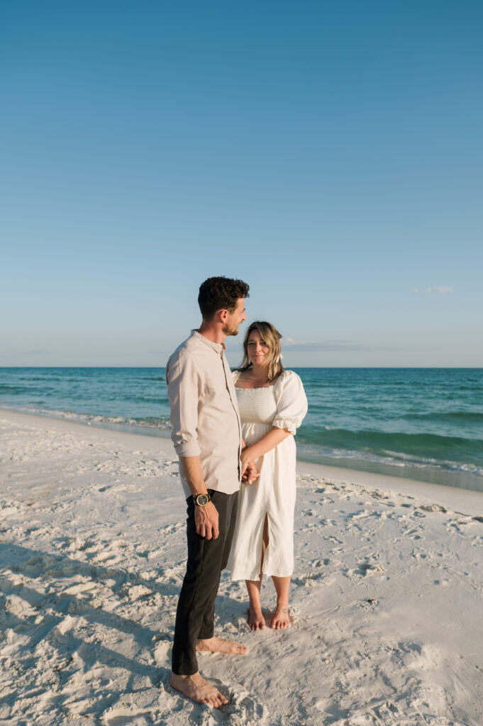 A couple posing in an editorial pose on Shell Island in Florida 