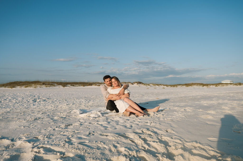 Couple snuggling on the beach in Florida 