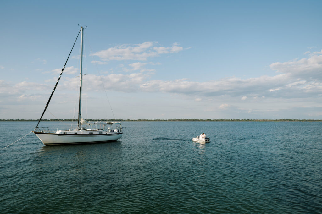 Couple coming to shore from their sailboat 