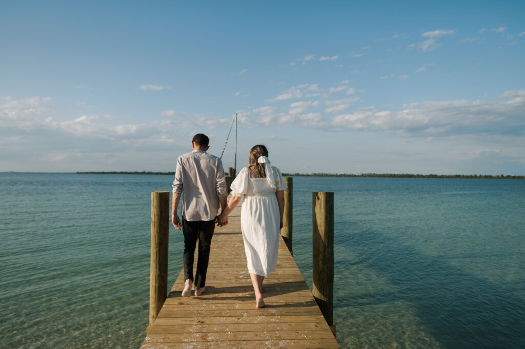 Couple walking on dock in Florida 