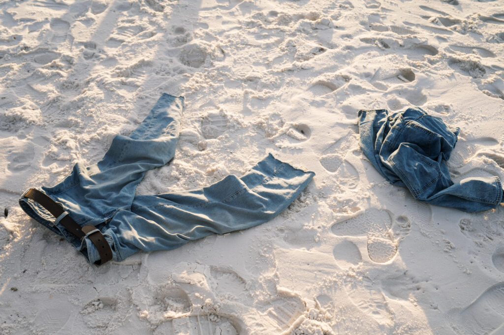Couples clothes laying on the beach 