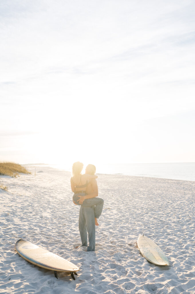 Couple snuggled up on the beach in Florida at sunrise