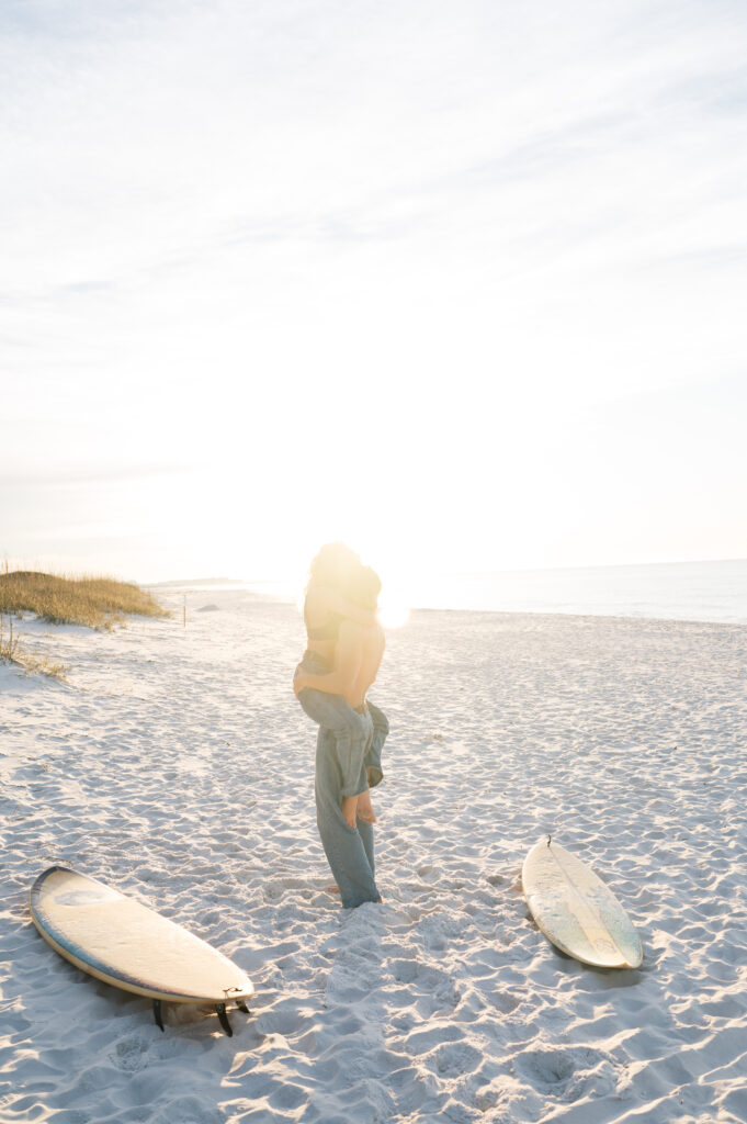 Couple kissing on the beach in Florida at sunrise 
