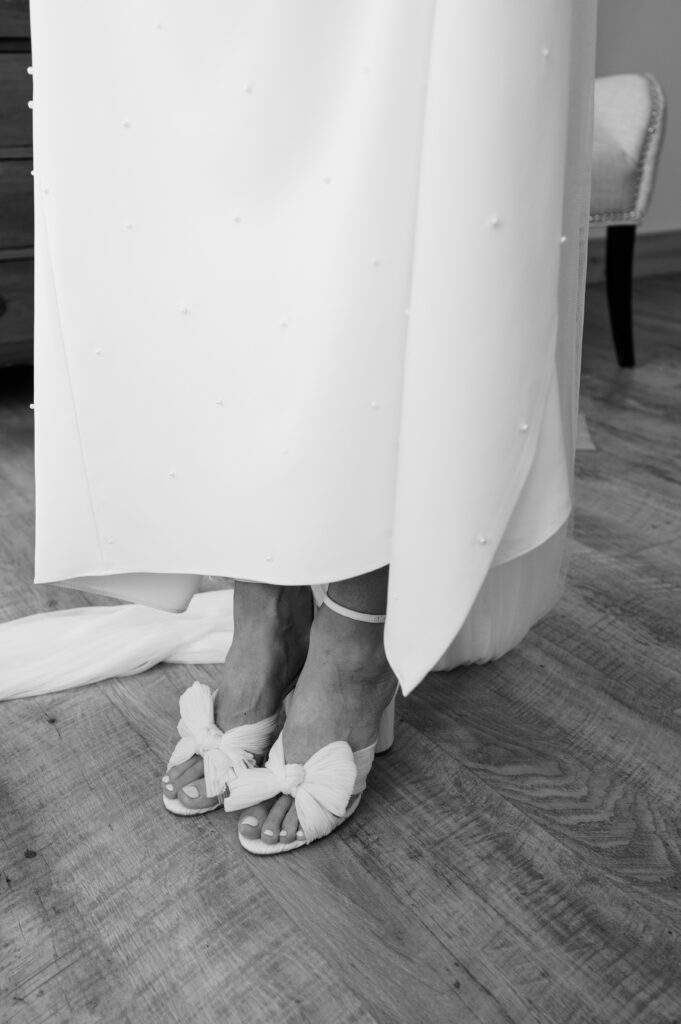 Detail shot of brides Loeffler Randall shoes and Sarah Seven dress 