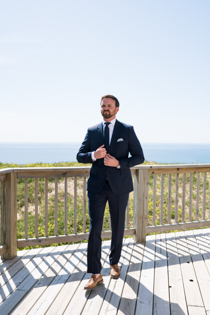 Groom posing with Lake Michigan in the background 